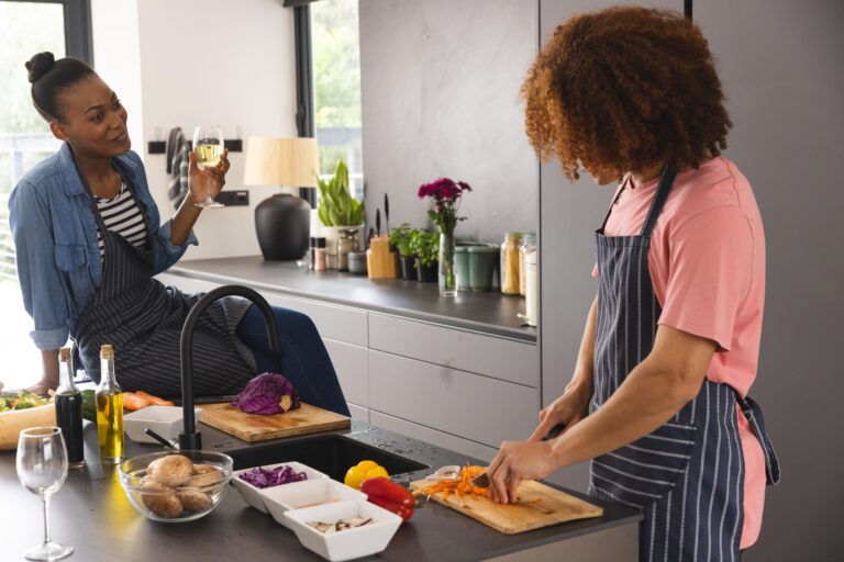 Two people cooking together in an open-plan kitchen